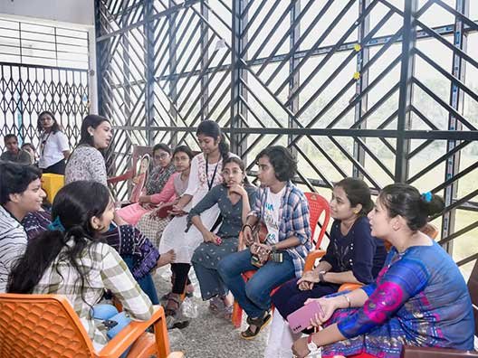 group-of-students-sitting-together-and-interacting-during-campus-break